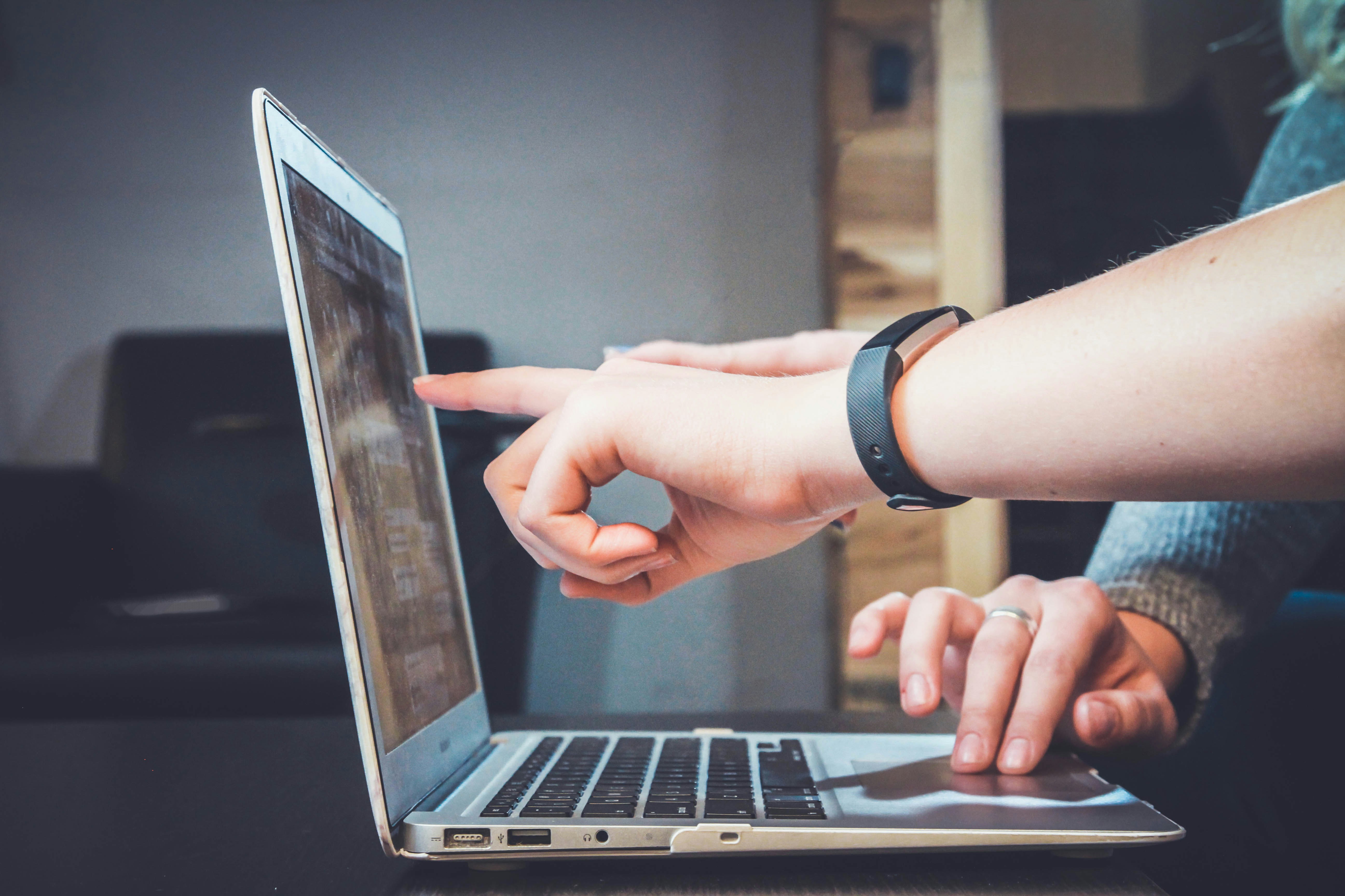 Website owner reviewing domain registrar and DNS settings on a laptop